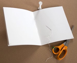 Make a working dummy by folding 8 sheets of paper and sewing or stapling them.