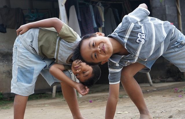 Two young boys acting silly in a street scene.