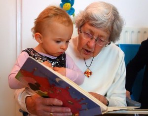 grandmother reading to baby