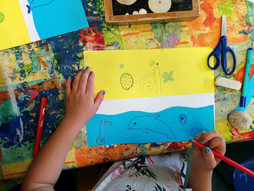 Kindergardeners made mixed media collages incorporating white negative space, like in the book.