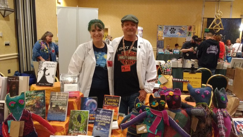 Corie and Sean Weaver at Bubonicon 2016 with their many books for sale